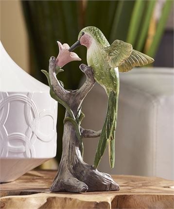 resin green hummingbird figurine on a flower